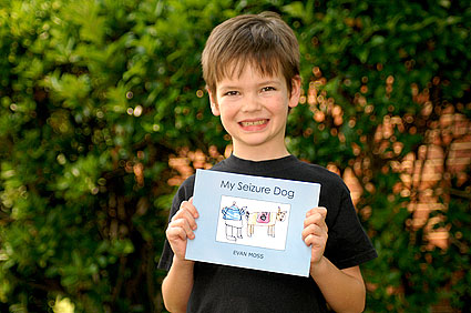 Evan Moss Holding His Seizure Dog Book
