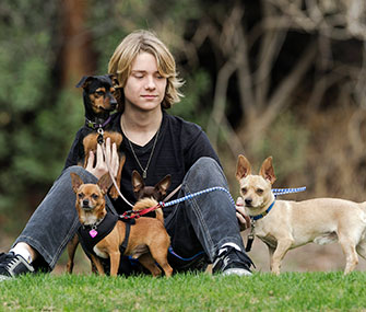 Actor Lou Wegner, 16, poses with his rescued dogs.