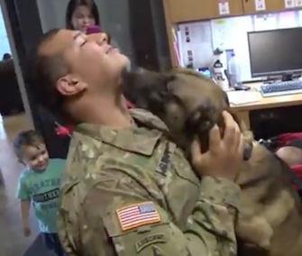 Spc. Andrew Brown gets smothered with kisses from his K9 partner, Rocky.