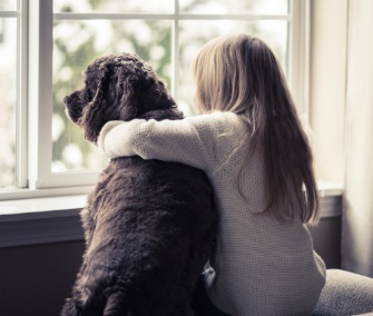 Girl with arm around dog