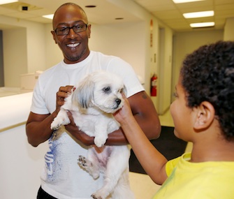 Kelly Booker and his son, Azzah, were reunited with their Shih Tzu, Lilly, Thursday.