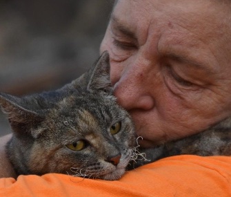 Debi Brusatori holds Ruthie Rosemary after finding her in the ruins of her burned out home.