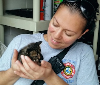 Firefighter Valerie Ligi adopted the 4-week-old kitten she saved from the fence post where he was trapped.
