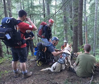 Balta takes a break with her owner and rescuers after bring saved from a ravine in Washington.