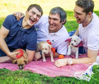 Washington Capitals players Dmitry Orlov, Alex Ovechkin and Evgeny Kuznetsov posed with Labrador mix puppies from Homeward Trails.