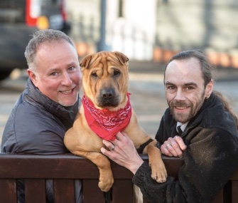Kai sits with his new owner, Ian Russell, left, and the Scottish SPCA's Alan Grant.
