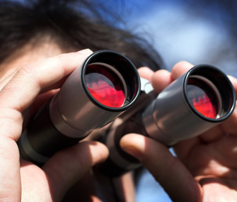 Birdwatcher looking through binoculars