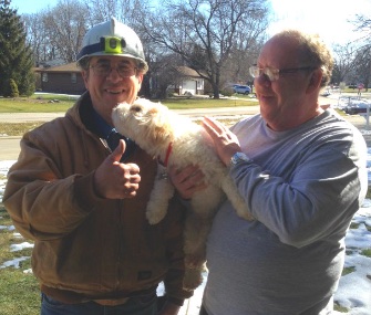 Job, a rescued blind and deaf dog, helped his neighbors by detecting a gas leak. He's pictured here with gas fitter John Albrecht, left, his owner, James Denmore.