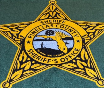 A rug at a Florida sheriff's office that was misprinted with "In Dog We Trust" is being auctioned for the benefit of an animal rescue.