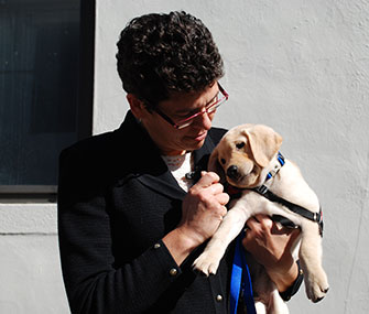 Dr. Otto holds one of her puppy pupils, Sirius, at the Penn Vet Working Dog Center.