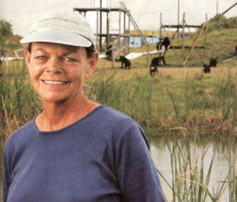 woman with apes in the background
