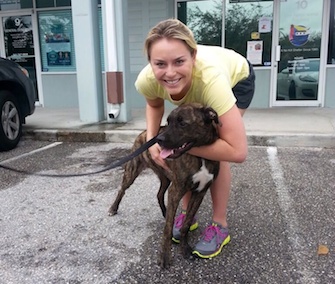 Lindsey Vonn poses with her puppy outside the animal shelter where she adopted him.