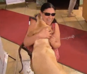 Maria Colon is reunited with her service dog, Yolanda, after a fire in their home.