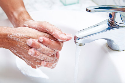 Man washing hands with soapy water