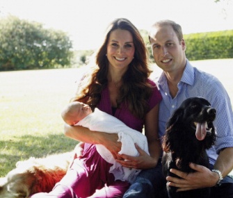 The Duchess of Cambridge and Prince William are pictured with their baby boy, Prince George, and dogs Tilly, left, and Lupo, right.