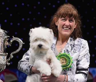 Breeder and handler Marie Burns holds Geordie Girl after her Best in Show win at Crufts.