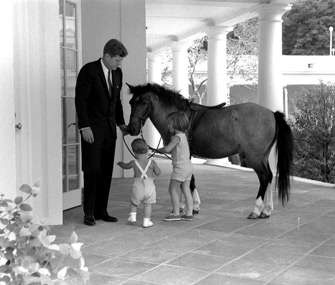 President John F. Kennedy with Caroline Kennedy's pony Macaroni