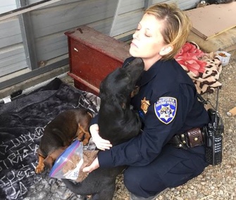 California Highway Patrol Officer Sarah Joyner gets some love from one of the dogs she rescued.