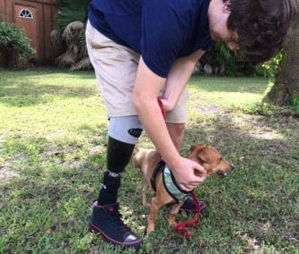 Sam Sartain, 16, pets his new dog, Pooh.