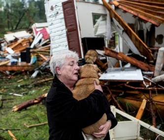 Constance Lambert embraces her dog after finding it in the rubble of her home in Tupelo, Mississippi.