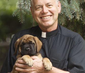 Rev. Patrick Beretta was reunited with his Mastiff puppy, Ysolt, after police freed him from the pipe where he was trapped.